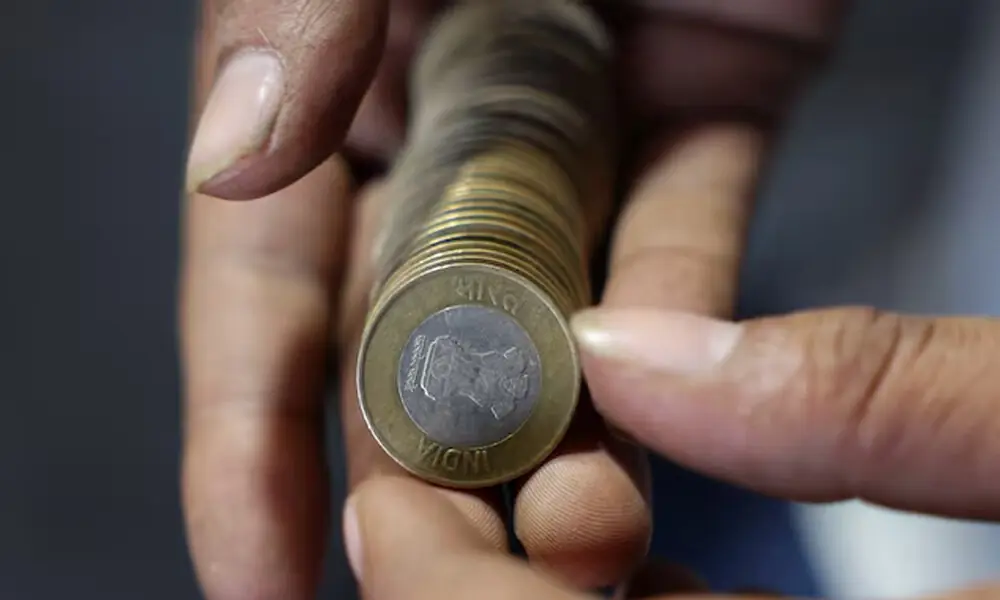 A shopkeeper counts Indian currency coins at his shop, in the old quarters of Delhi, India, September 24, 2025. REUTERS A shopkeeper counts Indian currency coins at his shop, in the old quarters of Delhi, India, September 24, 2025. REUTERS