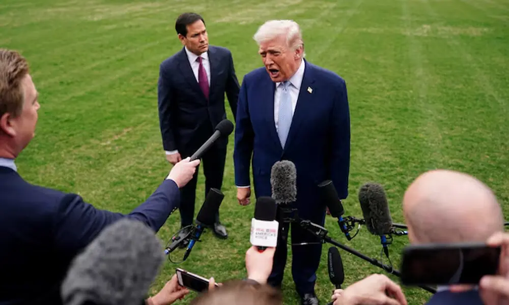 U.S. President Donald Trump speaks to the media, flanked by U.S. Secretary of State Marco Rubio, as he departs the White House for Florida, in Washington, D.C., U.S. Reuters