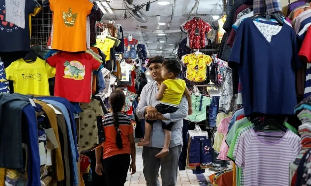 A family shops for children&rsquo;s dresses at a market in Karachi on April 19, 2023. Photo: Reuters