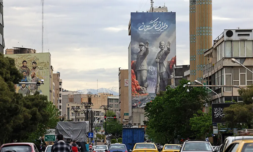 Commuters drive past a giant billboard referring to the &lsquo;Strait of Hormuz&rsquo; along a busy street in Tehran on April 19, 2026. Photo: AFP