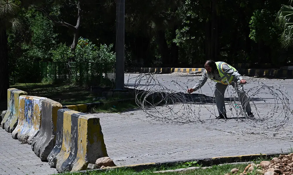 A traffic police personnel removes barricades from a closed street at the Red Zone area in Islamabad on April 26, 2026. Photo: AFP A traffic police personnel removes barricades from a closed street at the Red Zone area in Islamabad on April 26, 2026. Photo: AFP