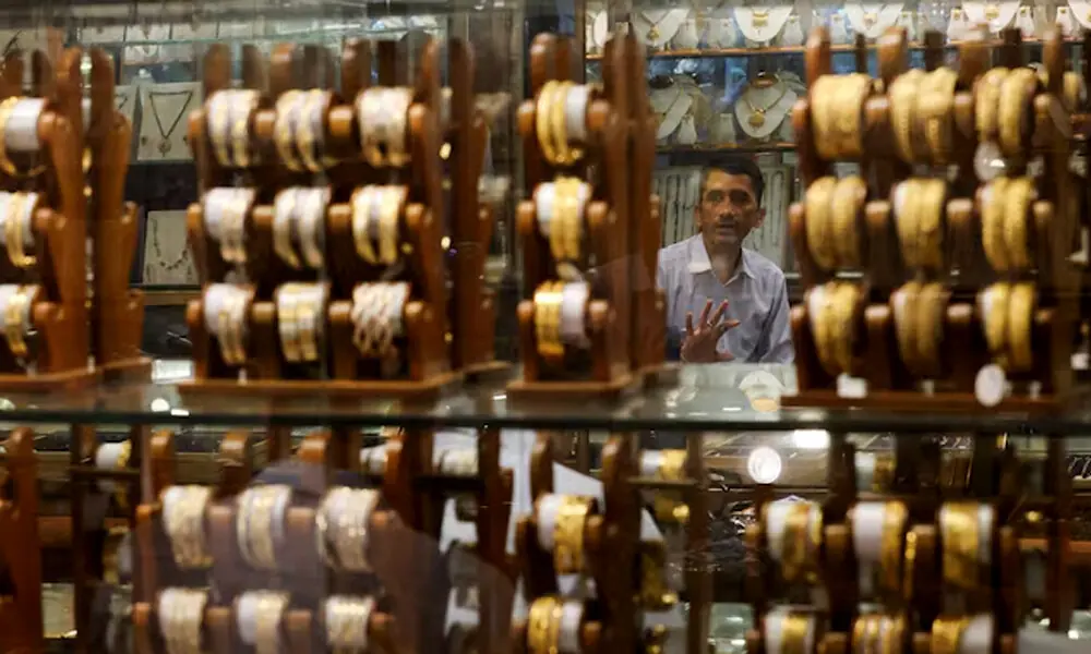 A salesperson talks to a customer at a jewellery shop in the old quarters of Delhi, India, May 24, 2023. REUTERS