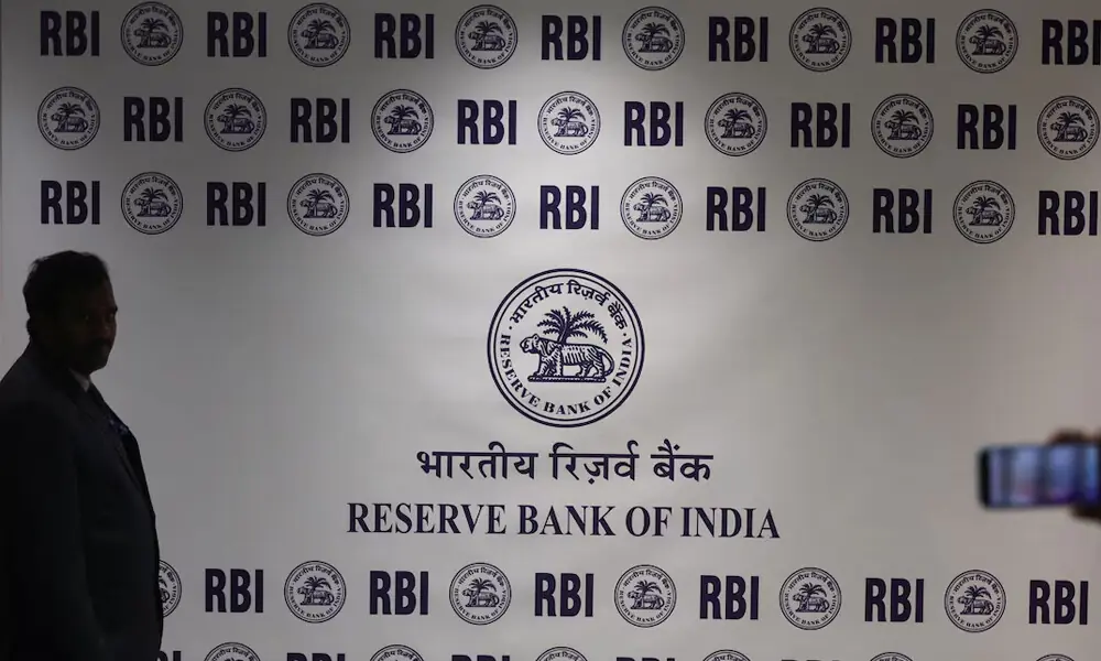 A man stands in front of the Reserve Bank of India (RBI) logo inside its headquarters in Mumbai, India, February 6, 2026. REUTERS