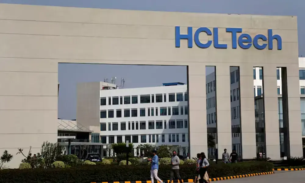 Employees of HCLTech walk inside the office premises on the outskirts of Lucknow, India. REUTERS