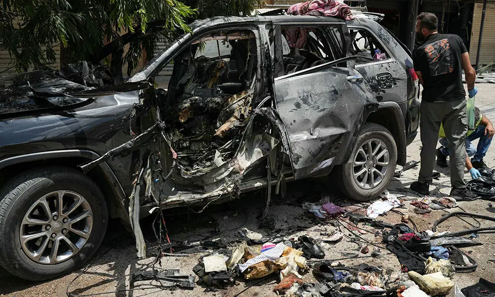 First responders inspect the wreckage of a car reportedly targeted by an Israeli strike in Nabatieh on July 6, 2026. Photo: AFP First responders inspect the wreckage of a car reportedly targeted by an Israeli strike in Nabatieh on July 6, 2026. Photo: AFP
