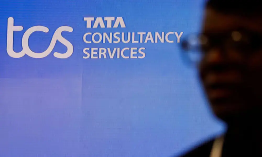 A man walks past a logo of Tata Consultancy Services (TCS) before a press conference announcing the company's quarterly results in Mumbai, India, January 11, 2024. File Photo: Reuters A man walks past a logo of Tata Consultancy Services (TCS) before a press conference announcing the company's quarterly results in Mumbai, India, January 11, 2024. File Photo: Reuters