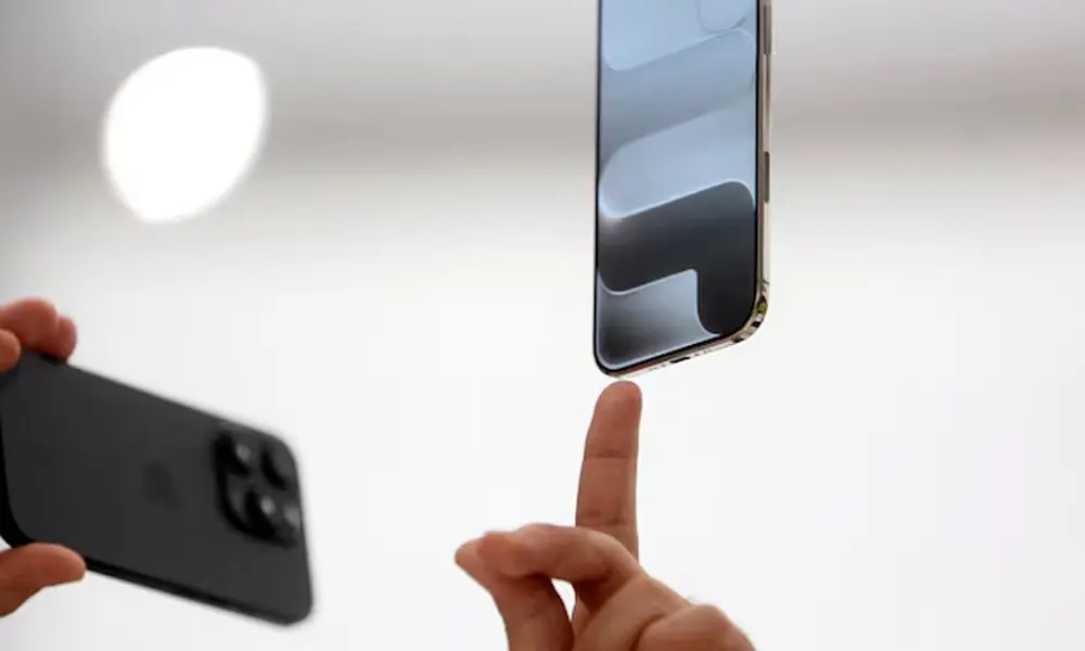 A person points to an iPhone during Apple's event at the Steve Jobs Theater on its campus in Cupertino, California, U.S. September 9, 2025. REUTERS