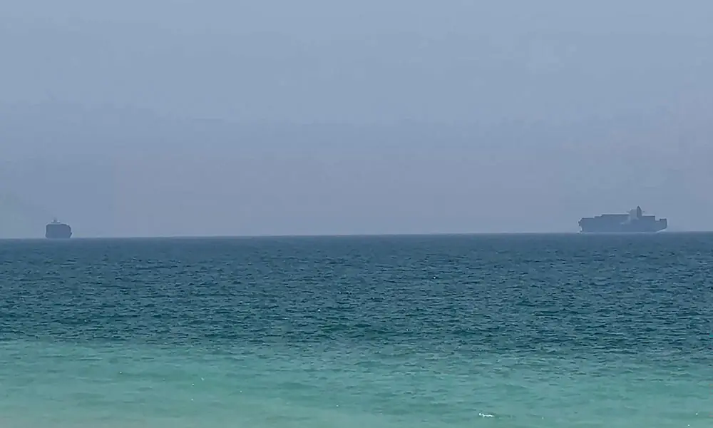 This frame grab taken from AFPTV video footage on July 12, 2026 shows cargo ships anchoring near the Strait of Hormuz off the eastern coast of the United Arab Emirates at Khor Fakkan. Photo: AFP