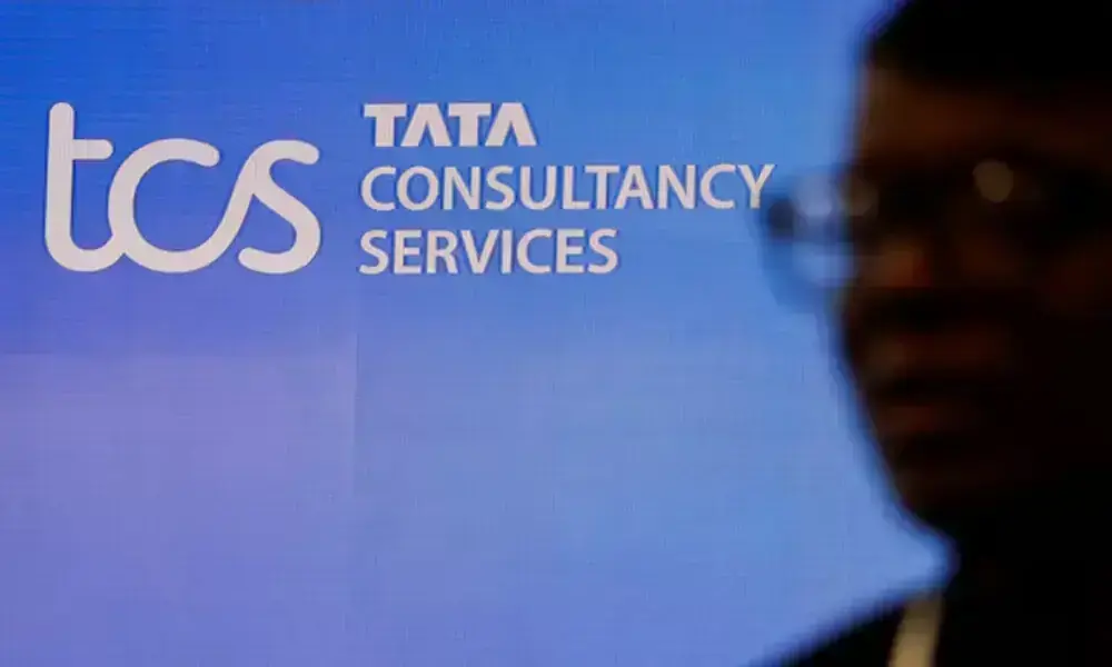 A man walks past a logo of Tata Consultancy Services (TCS) before a press conference announcing the company's quarterly results in Mumbai, India, January 11, 2024. REUTERS A man walks past a logo of Tata Consultancy Services (TCS) before a press conference announcing the company's quarterly results in Mumbai, India, January 11, 2024. REUTERS