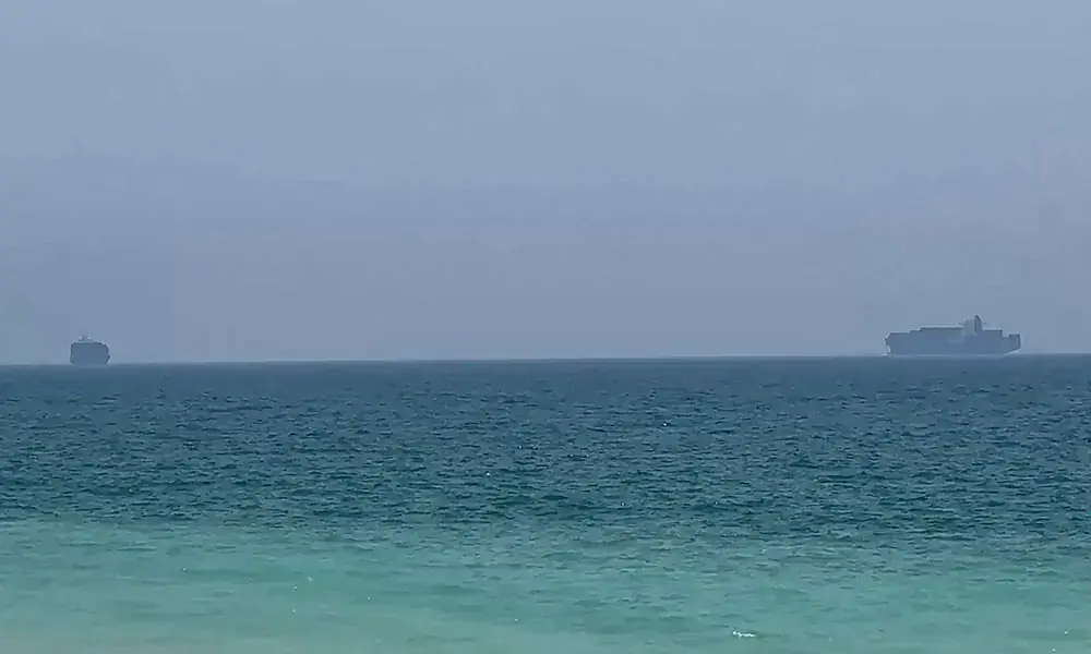 This frame grab taken from AFPTV video footage on July 12, 2026 shows cargo ships anchoring near the Strait of Hormuz off the eastern coast of the United Arab Emirates at Khor Fakkan. Photo: AFP