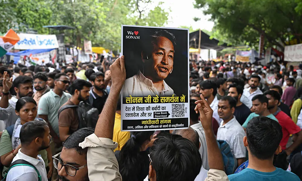 A supporter holds a photograph of climate activist Sonam Wangchuk during a sit-in protest demanding the resignation of India's Education Minister Dharmendra Pradhan over alleged NEET examination irregularities in New Delhi on July 19, 2026. Photo: AFP A supporter holds a photograph of climate activist Sonam Wangchuk during a sit-in protest demanding the resignation of India's Education Minister Dharmendra Pradhan over alleged NEET examination irregularities in New Delhi on July 19, 2026. Photo: AFP