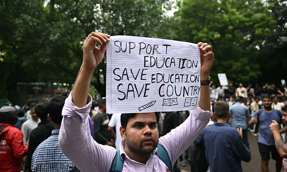 A Cockroach Janta Party (CJP) supporter holds a placard at Jantar Mantar in New Delhi on July 22, 2026 during the ongoing protest to demand the resignation of India's Education Minister Dharmendra Pradhan over alleged NEET exam irregularities. Photo: AFP A Cockroach Janta Party (CJP) supporter holds a placard at Jantar Mantar in New Delhi on July 22, 2026 during the ongoing protest to demand the resignation of India's Education Minister Dharmendra Pradhan over alleged NEET exam irregularities. Photo: AFP