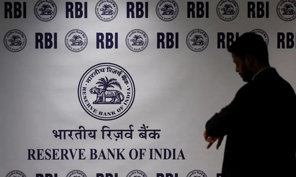 A man stands in front of the Reserve Bank of India (RBI) logo inside its headquarters in Mumbai, India, February 6, 2026. REUTERS