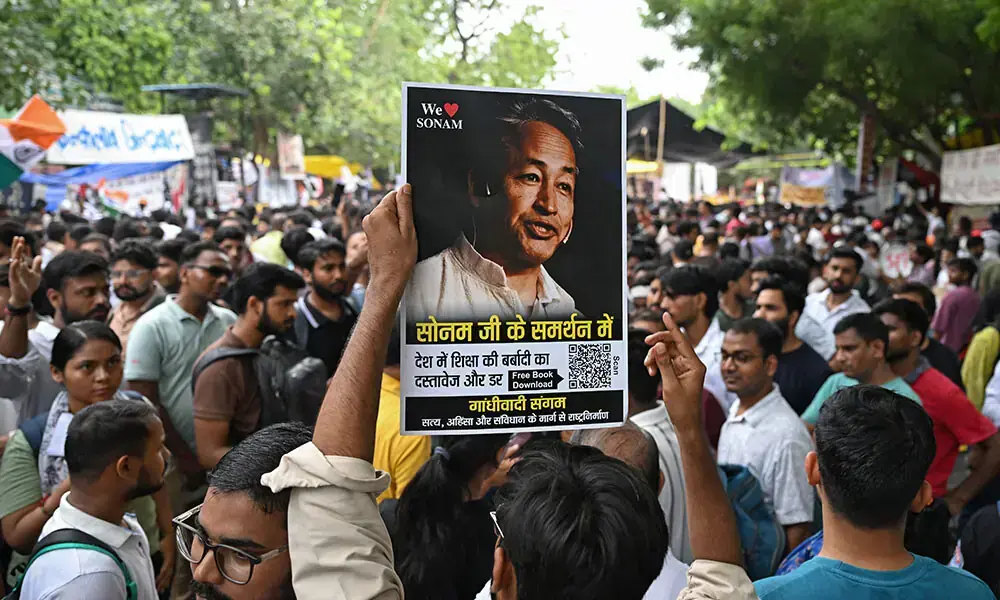 A supporter holds a photograph of climate activist Sonam Wangchuk during a sit-in protest demanding the resignation of India's Education Minister Dharmendra Pradhan over alleged NEET examination irregularities in New Delhi on July 19, 2026. Photo: AFP A supporter holds a photograph of climate activist Sonam Wangchuk during a sit-in protest demanding the resignation of India's Education Minister Dharmendra Pradhan over alleged NEET examination irregularities in New Delhi on July 19, 2026. Photo: AFP