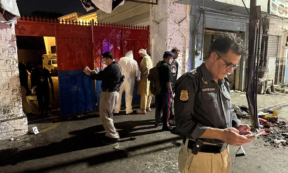 Police officials inspect the site following a suicide bombing during a protest in Pakistan's Swat district on August 2, 2026. Photo: AFP