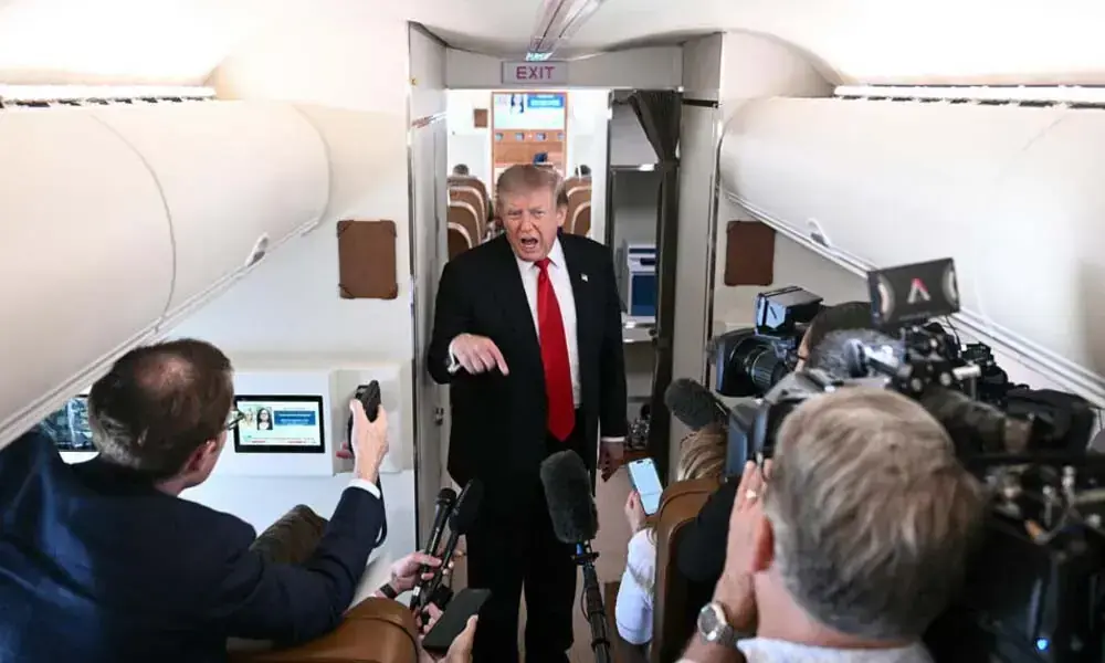 President Donald Trump speaks with members of the press aboard Air Force One. Photo: AFP President Donald Trump speaks with members of the press aboard Air Force One. Photo: AFP