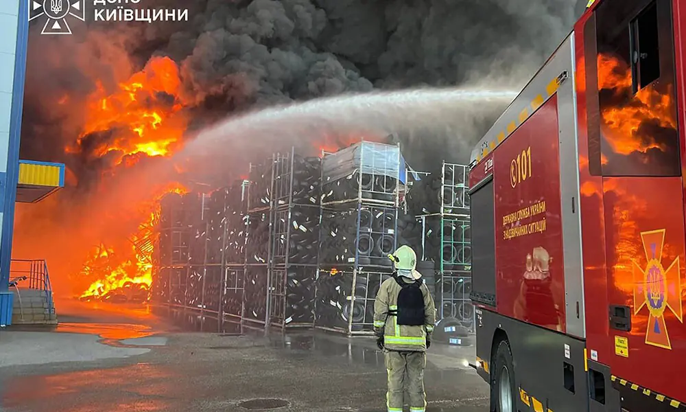 In this handout photograph taken and released by the Ukrainian Emergency Service on August 29, 2026, a Ukrainian rescuer stand next to a truck with a spray of water as they work to extinguish a fire in a warehouse following an air attack at an undisclosed location in the Kyiv region, amid the Russian invasion of Ukraine. Photo: AFP