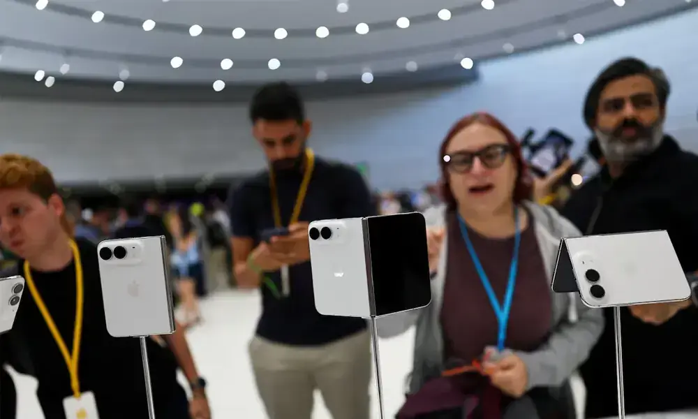 People look at the new foldable iPhone Duo devices on display during Apple's event at the Steve Jobs Theater in Cupertino, California, U.S. September 9, 2026. REUTERS
