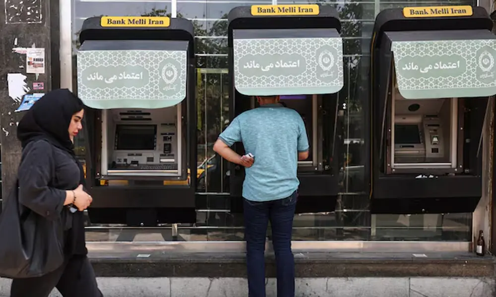 A man uses an ATM of Bank Melli Iran. Reuters