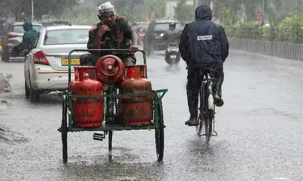 A worker transporting cylinders looks on as rain falls in the aftermath of Cyclone Ditwah, in Chennai, India, December 1, 2025. File Photo: Reuters A worker transporting cylinders looks on as rain falls in the aftermath of Cyclone Ditwah, in Chennai, India, December 1, 2025. File Photo: Reuters