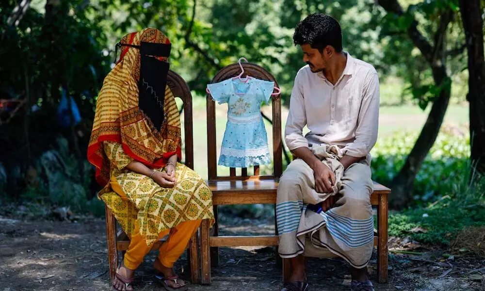 The parents of Labiba Akter have kept a blue dress once worn by their nine-month-old daughter, who died of measles in June, as a keepsake. They were not told she was eligible for a vaccination before she contracted the disease. Reuters