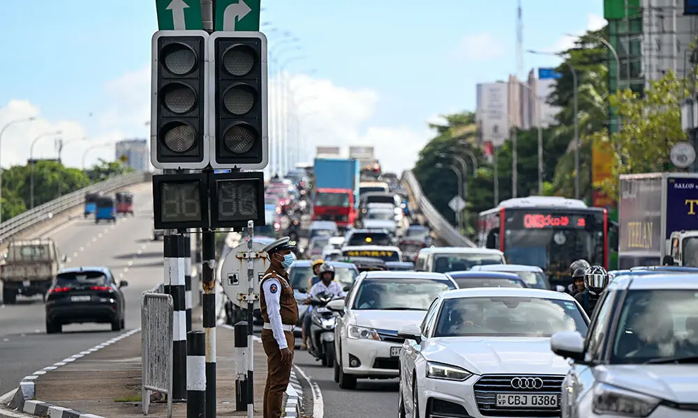 Commuters ride past inoperative traffic lights following a nationwide electricity blackout in Colombo on October 17, 2026. Photo: AFP Commuters ride past inoperative traffic lights following a nationwide electricity blackout in Colombo on October 17, 2026. Photo: AFP
