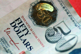 Asian currencies mixed in thin trading, Chinese yuan falls most