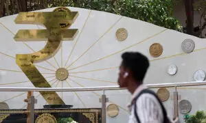 Indian rupee dragged by weak equities, hovers near record-low levels against yuan