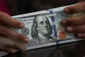 Dollar edges up against euro, franc