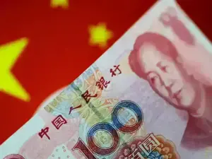 Yuan edges lower in tight range as pre-holiday flows ebb