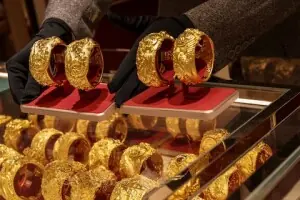 Gold dips as dollar firms ahead of inflation data