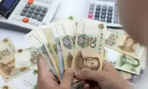 China's yuan weakens slightly against dollar as US-Iran talk in focus
