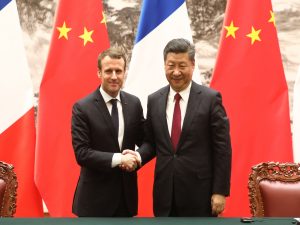 France signs deals with China but warns against 'pillaging'