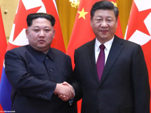 Korea's Kim shows unity with China's Xi in first foreign trip